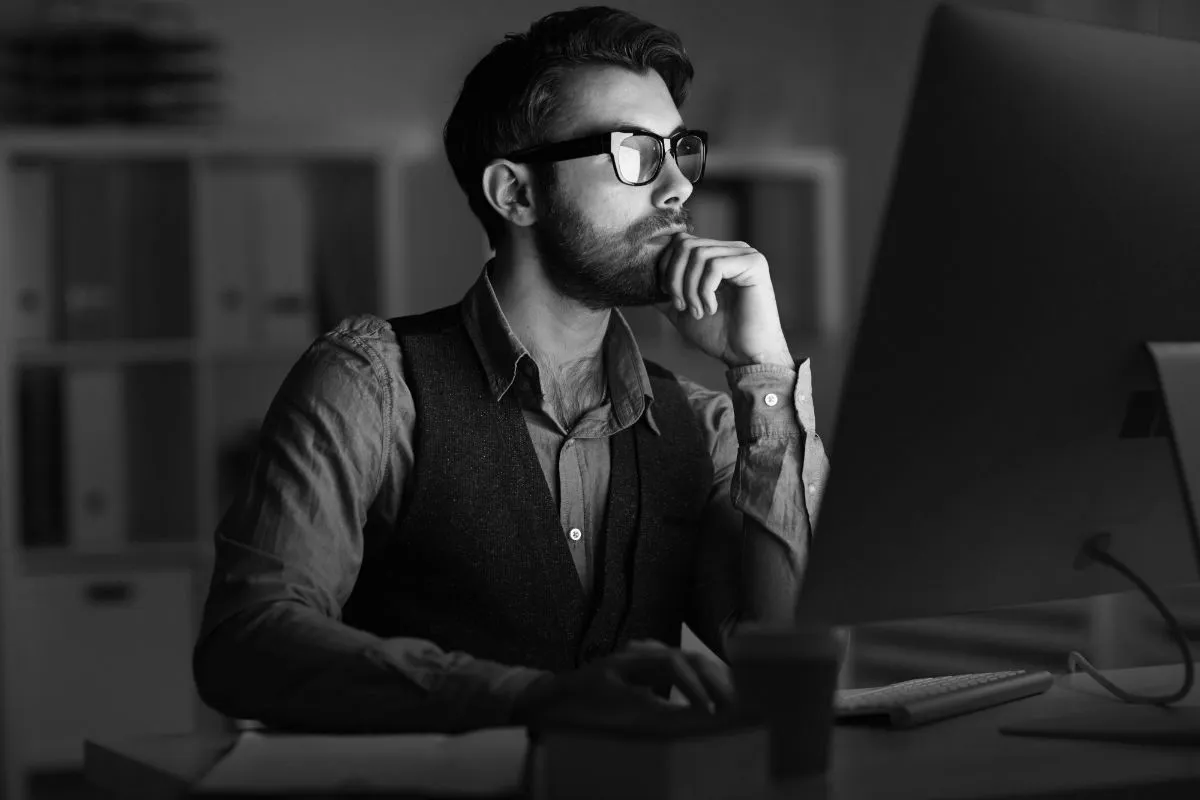 A person sitting at a desk in front of a computer